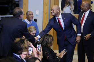 Maryland Gov. Wes Moore greets people before President Joe Biden speaks about the economy at the International Brotherhood of Electrical Workers Local 26 on Feb. 15, 2023 in Lanham, Maryland. Credit: Chip Somodevilla/Getty Images